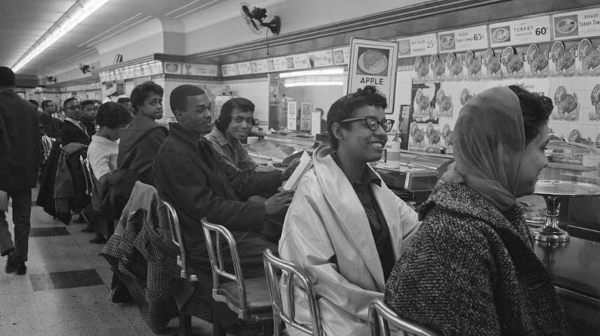 Black students line the counter of a dime store in protest for the store's refusal to serve them.