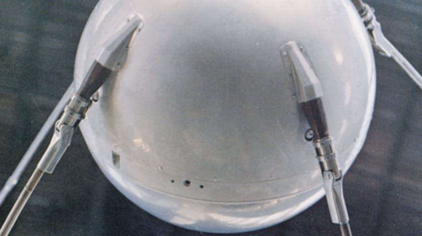 A silver metal ball with four metal antennae coming out of it that were used to send beeping radio signals back to earth