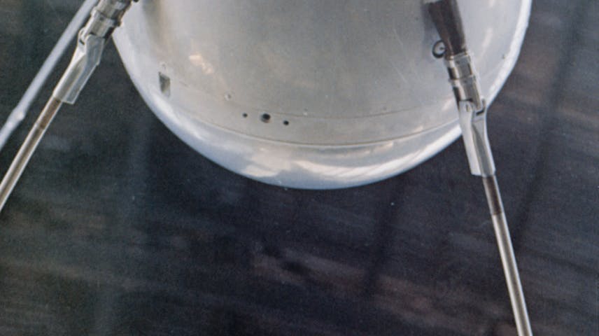 A silver metal ball with four metal antennae coming out of it that were used to send beeping radio signals back to earth
