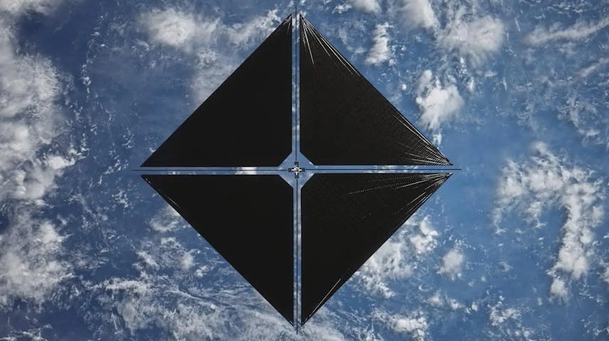 A solar sail spacecraft floating in orbit above Earth. It has four large, dark triangular panels arranged in a diamond shape, connected by thin silver rods at the center. Below it, Earth's blue oceans and white clouds are visible.