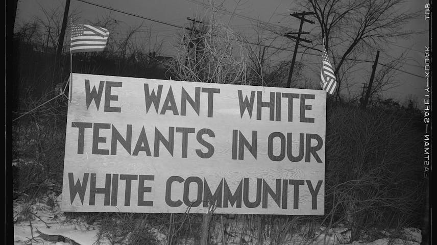 Sign, including American flags, that says, “We want white tenants in our white community.”