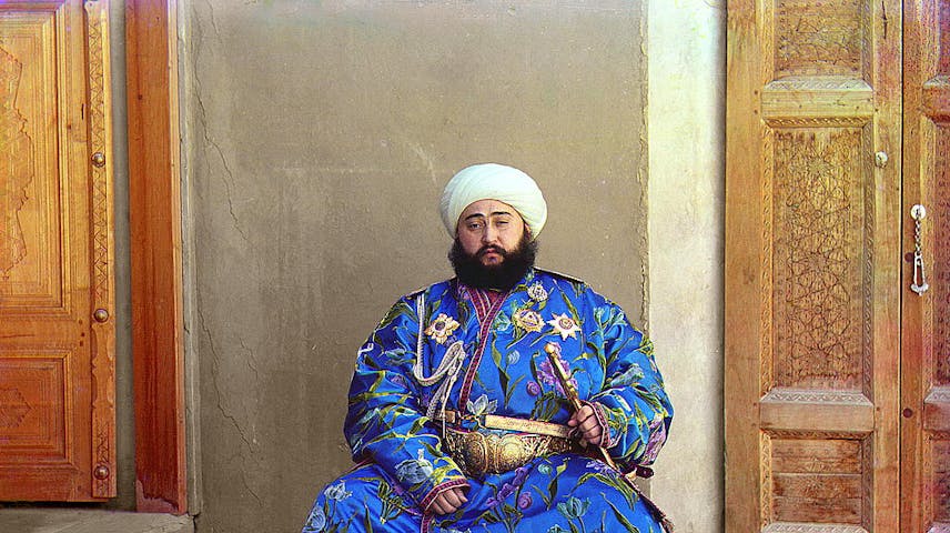 A seated man with a sword and in traditional dress of the city-state of Bukhara.